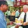 Dave Thomas (right) serves a meal to a Wendy's customer. (Photo courtesy Edmonds Community College)